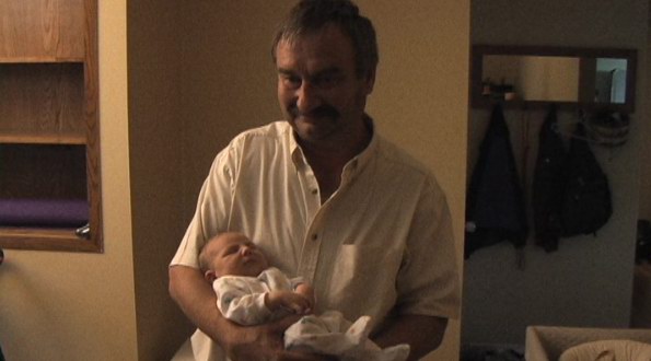 Gary the proud new grandfather holding Owen