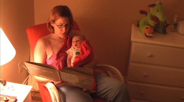 Judith reads a book to Owen
