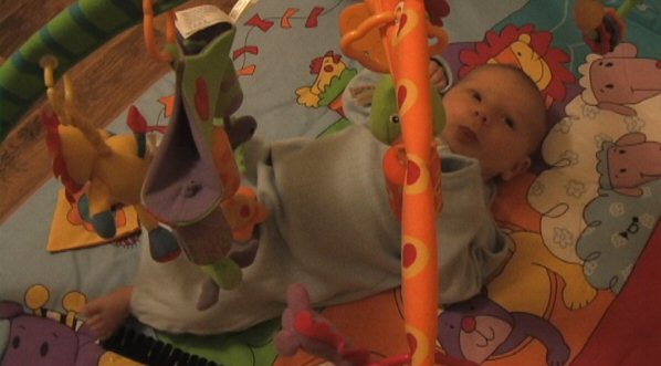 Keeping himself amused on a toy play thing